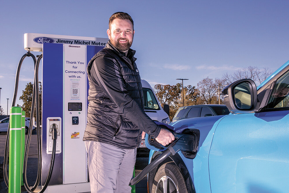 BATTERY BOOST; Jimmy Michel Motors General Sales Manager Taylor House charges a vehicle at the Aurora dealership using equipment installed by Dynamic EVC.